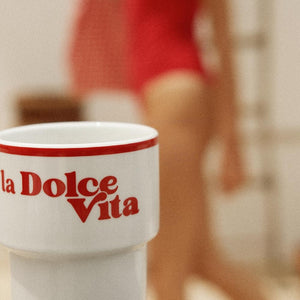 a soft, comforting ceramic mug with la dolce vita design held in hand on a cozy morning