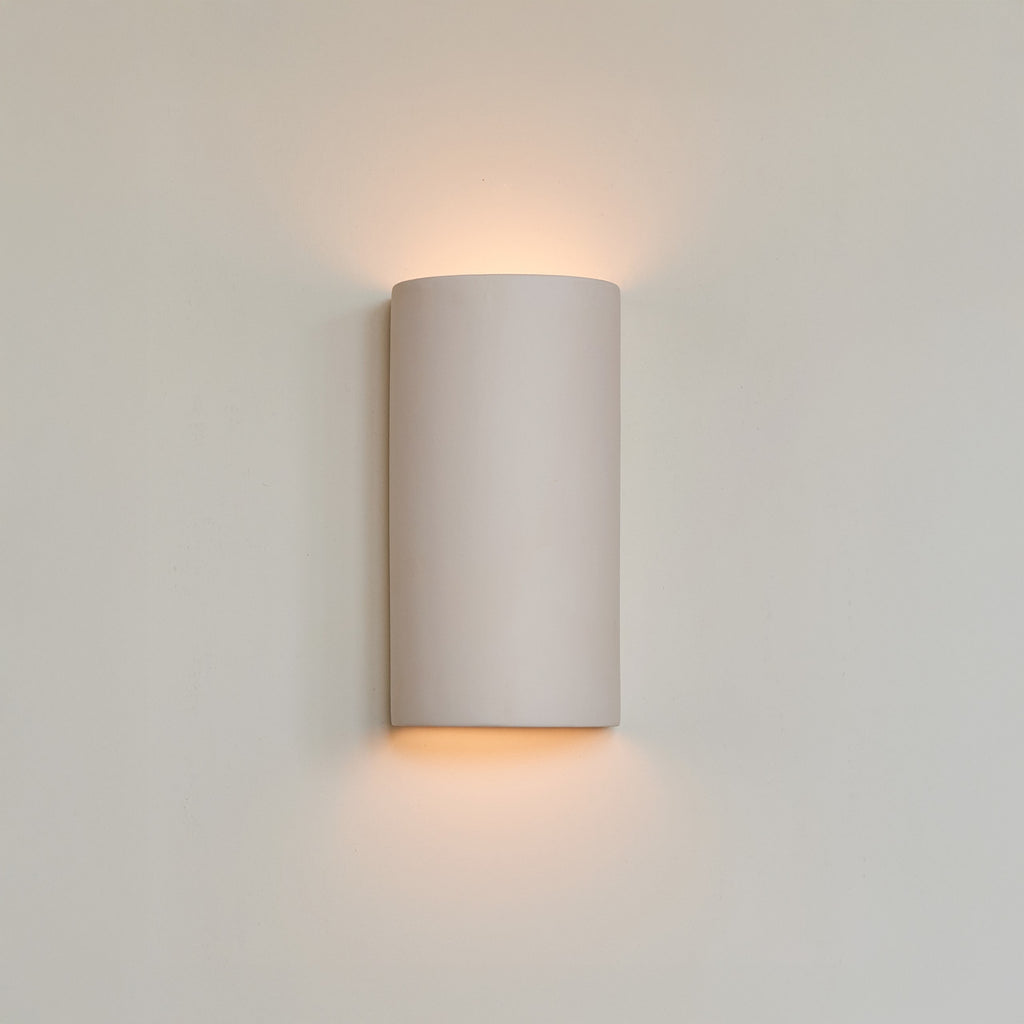 a bold close-up of the handcrafted curve sconce in extra matte white, showcasing its sculptural form