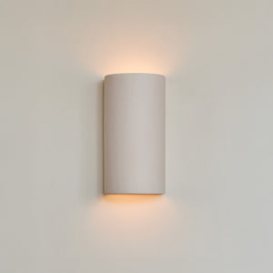 a bold close-up of the handcrafted curve sconce in extra matte white, showcasing its sculptural form