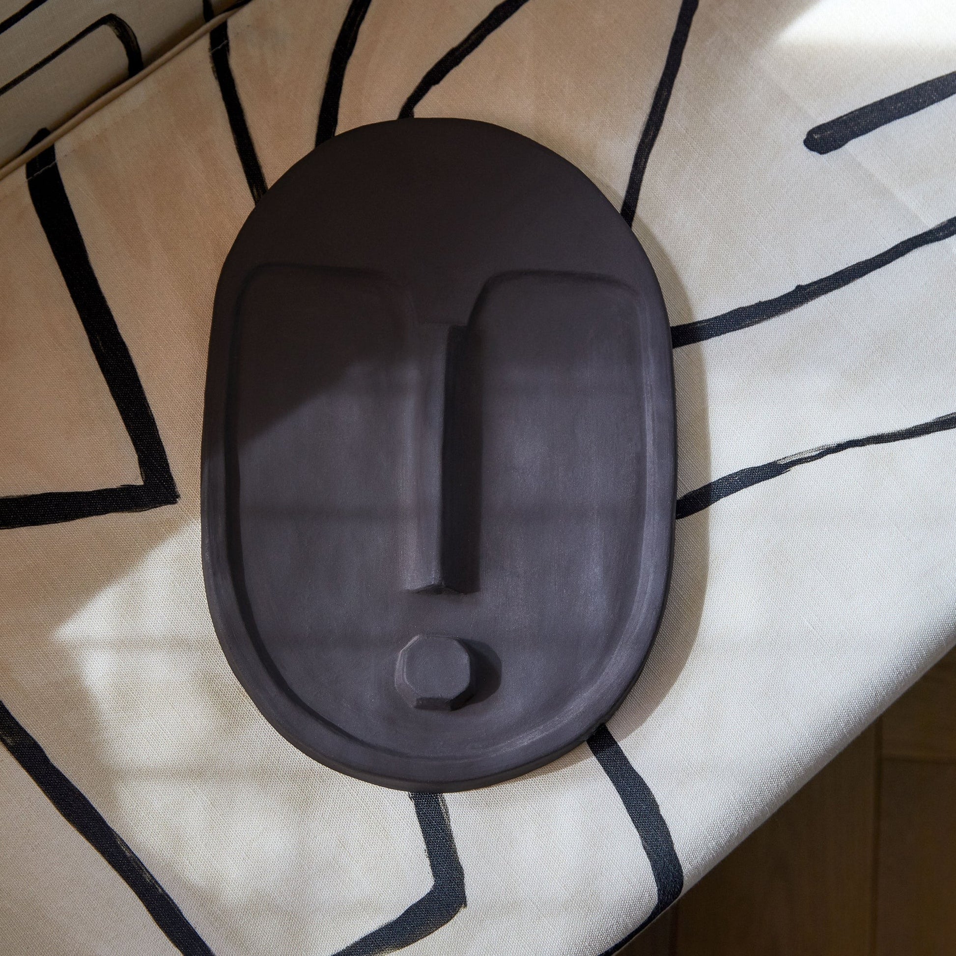bold anthracite grey ceramic wall mask with textured terracotta glaze, modern abstract art for minimalist decor
