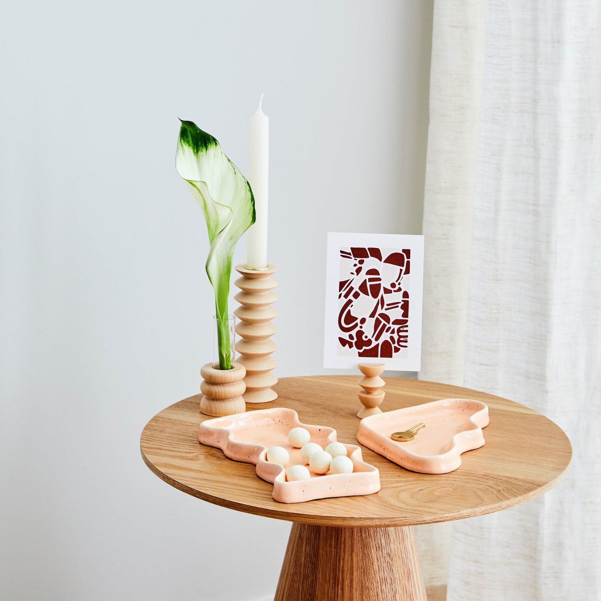 playful speckled peach ceramic tray overflowing with colorful jewelry on a sunny windowsill