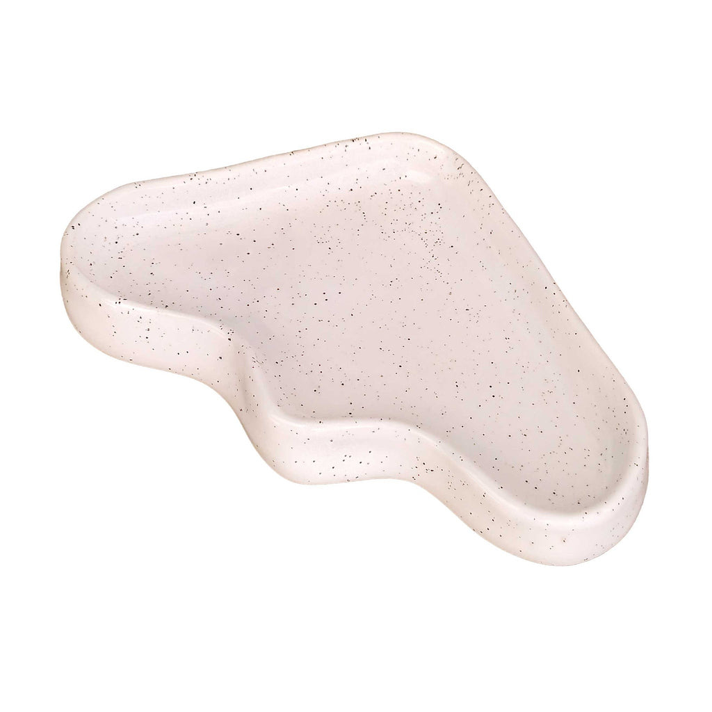 a playful speckled white ceramic triangle tray for keys on a sunny windowsill