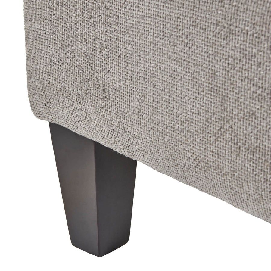 Taupe velvet ottoman footstool with wooden legs, plush cushioning, and modern farmhouse design by Sostter at brixbailey.com