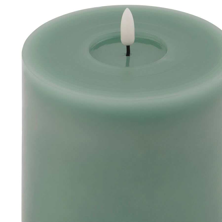 Sage green LED wax candle with realistic melting effect, flameless and energy-efficient for warm ambiance by Sostter at brixbailey.com