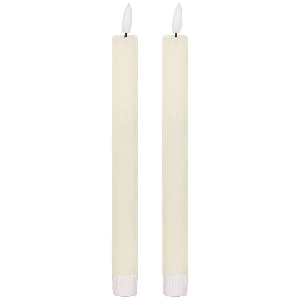 Elegant ivory LED dinner candle with warm flickering glow, flameless and smokeless, 25cm tall for stylish table decor by RoomLondon at brixbailey.com