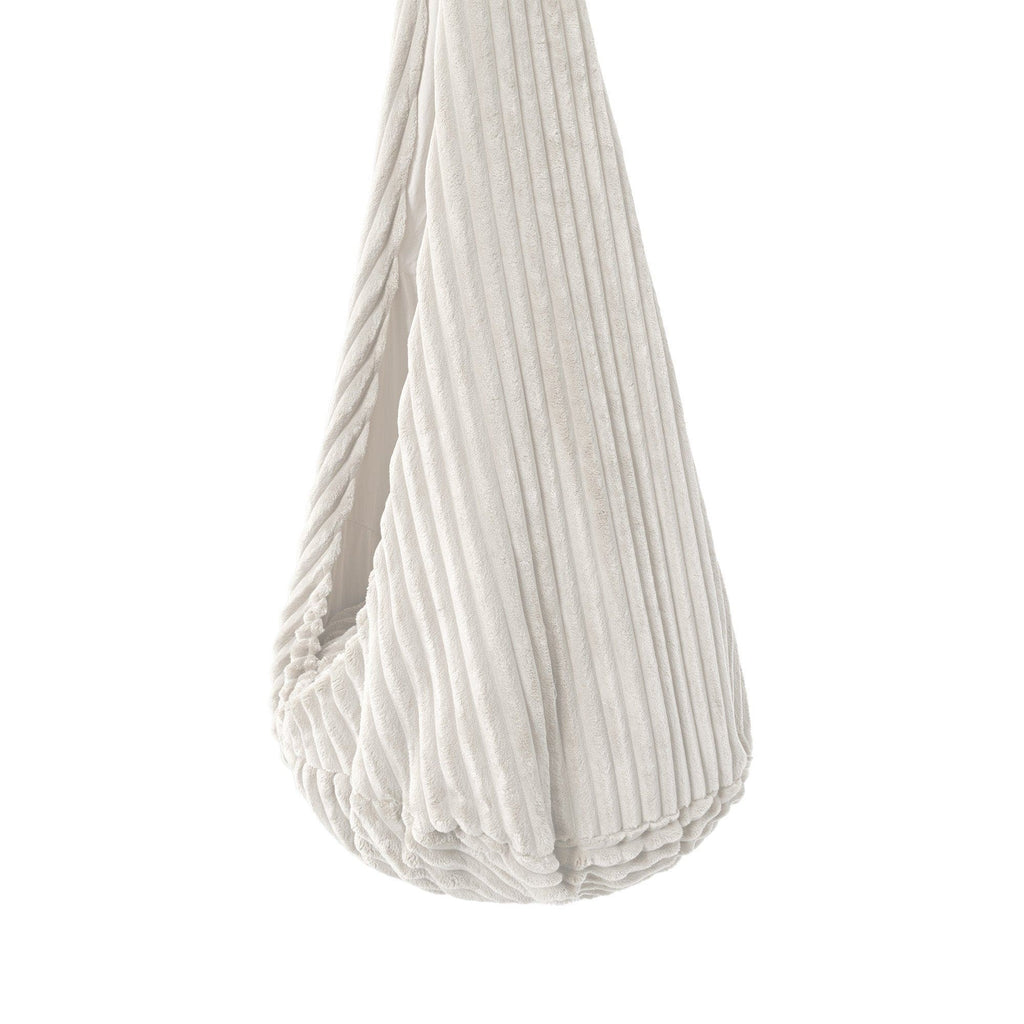 a child laughing in the white cotton candy cocoon swing, playful afternoon light