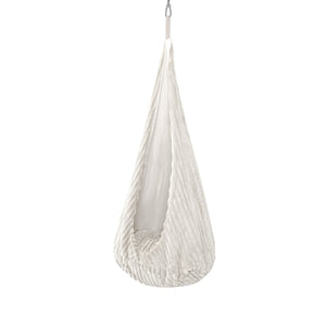 soft white cocoon swing for a child, gently swaying in a sunlit nursery corner