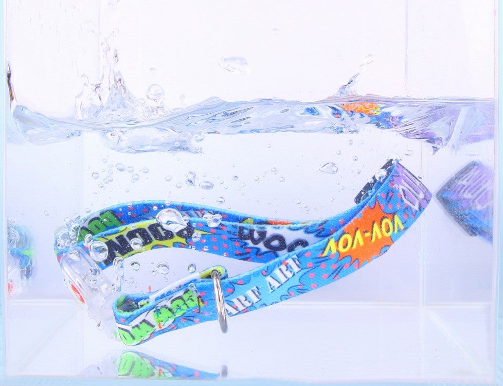 a gentle close-up of a blue graffiti led dog collar glowing softly in the evening light