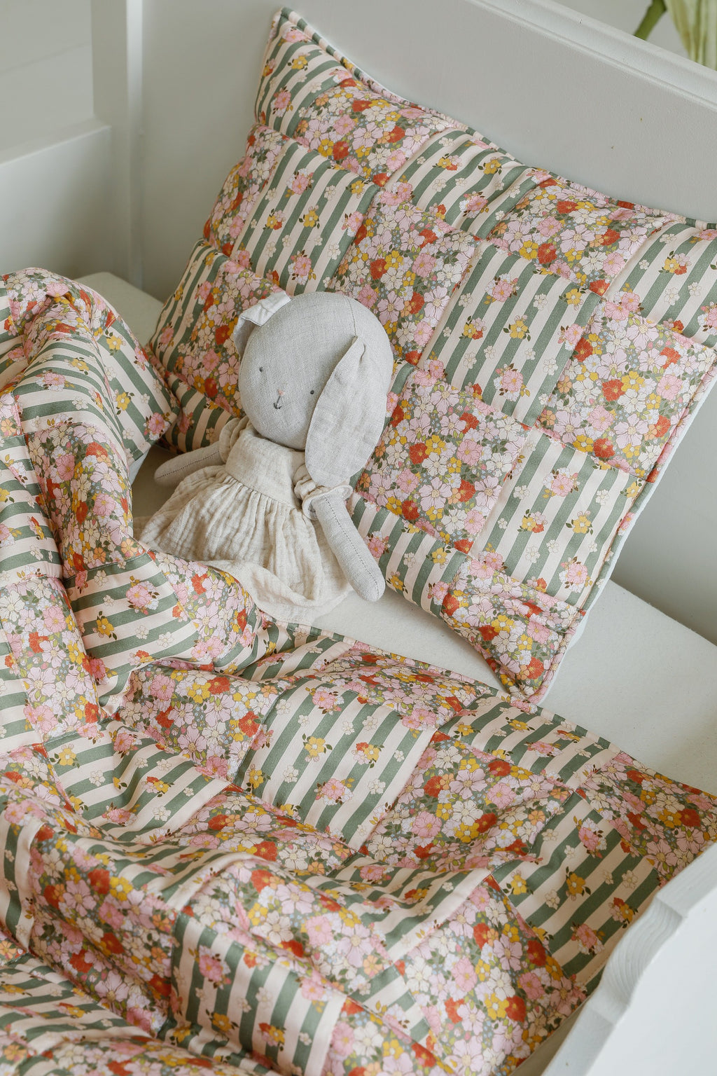 bold green garden cotton quilted blanket and pillow set, patchwork design on a neutral background