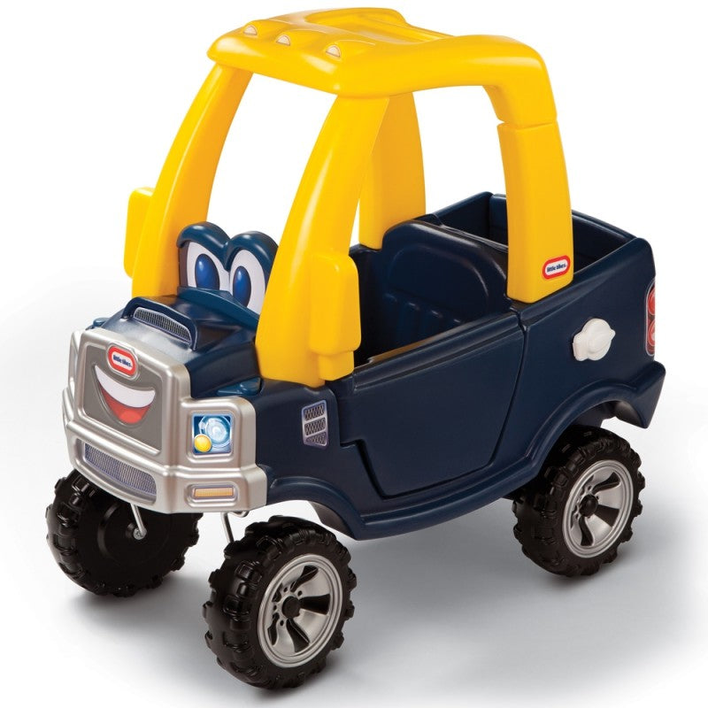 a young child playing with a cozy truck ride-on toy in a sunlit backyard adventure