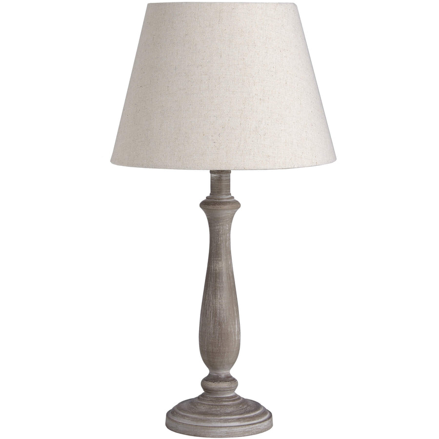 Rustic table lamp with whitewashed wood base and linen shade, warm beige tones for cozy ambient lighting. by Hill Interiors at brixbailey.com