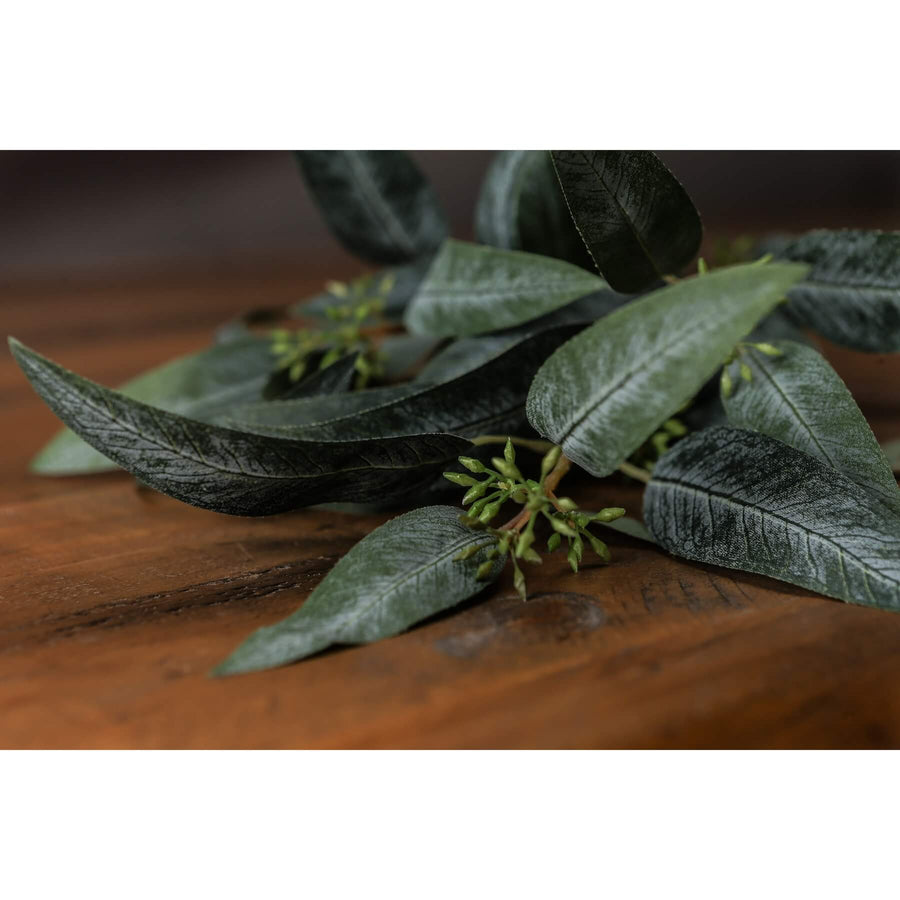 Lifelike seeded eucalyptus spray with green leaves and pods, perfect for farmhouse or boho home decor arrangements by Sostter at brixbailey.com
