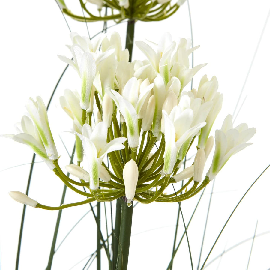 White faux agapanthus arrangement in black pot, lifelike plastic blooms with green foliage, 120cm tall by Sostter at brixbailey.com