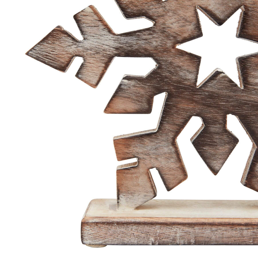 Whitewashed wooden snowflake decoration with intricate laser-cut Nordic design, perfect for winter and rustic home decor. by Sostter at brixbailey.com