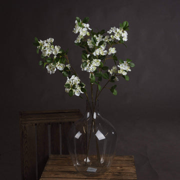 Realistic white mock orange blossom spray with delicate petals and leaves, perfect for home decor by Sostter at brixbailey.com