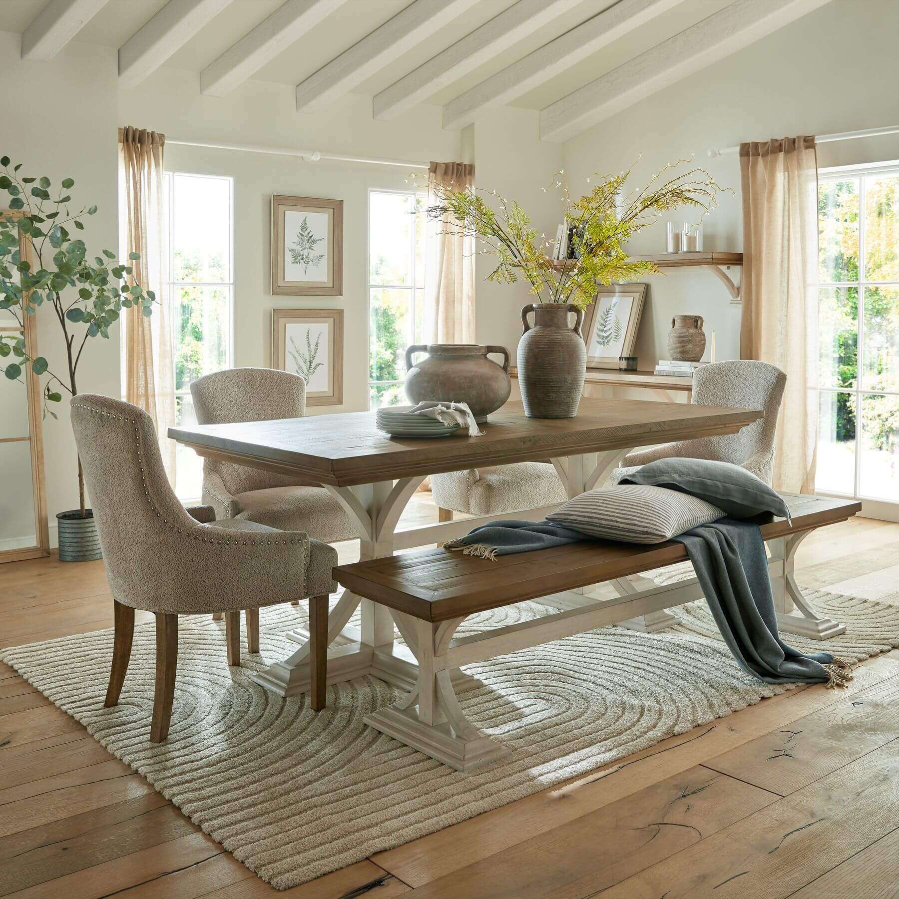 Rustic pine farmhouse dining bench with white legs, natural wood grain, and modern farmhouse style by Sostter at brixbailey.com