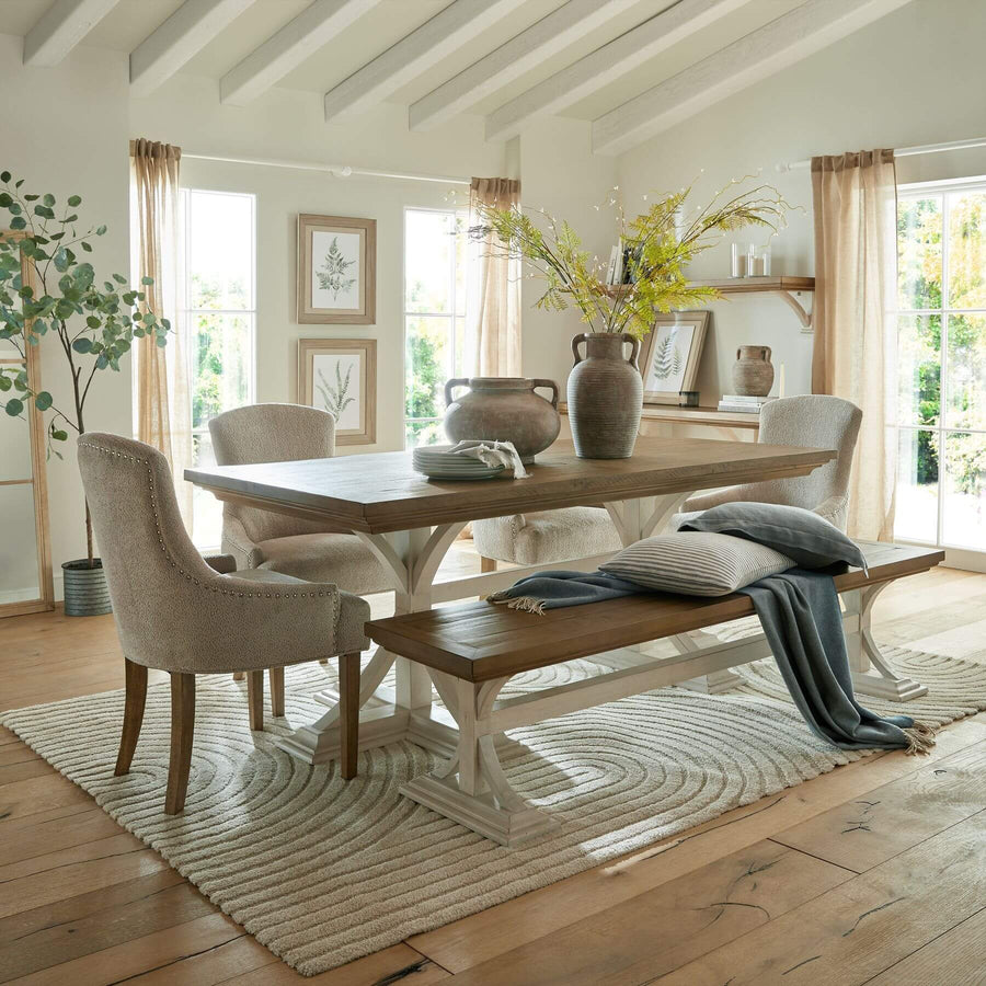 Rustic pine farmhouse dining bench with white legs, natural wood grain, and modern farmhouse style by Sostter at brixbailey.com