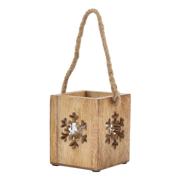 Handcrafted wooden snowflake tealight holder with glass accents, casting warm winter shadows on natural wood. by Sostter at brixbailey.com