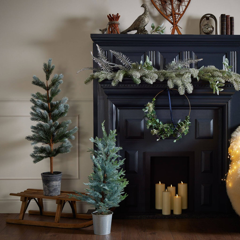120cm artificial fir tree with lifelike needles and pinecones in natural green, displayed in neutral stone base by Sostter at brixbailey.com