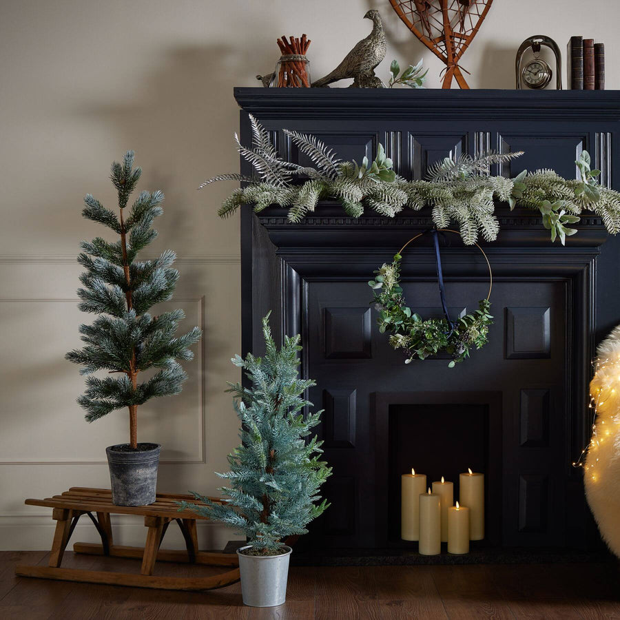 120cm artificial fir tree with lifelike needles and pinecones in natural green, displayed in neutral stone base by Sostter at brixbailey.com