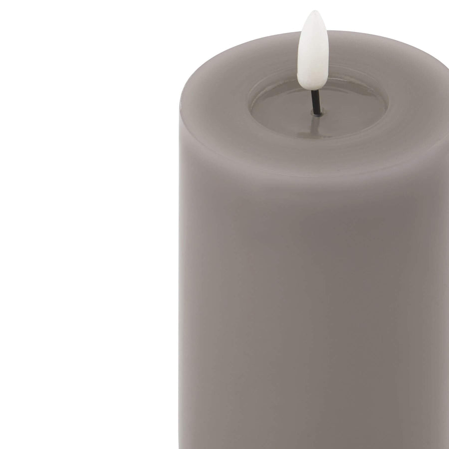 Grey LED wax candle with realistic dripping effect and warm glow, perfect for modern decor. by Hill Interiors at brixbailey.com