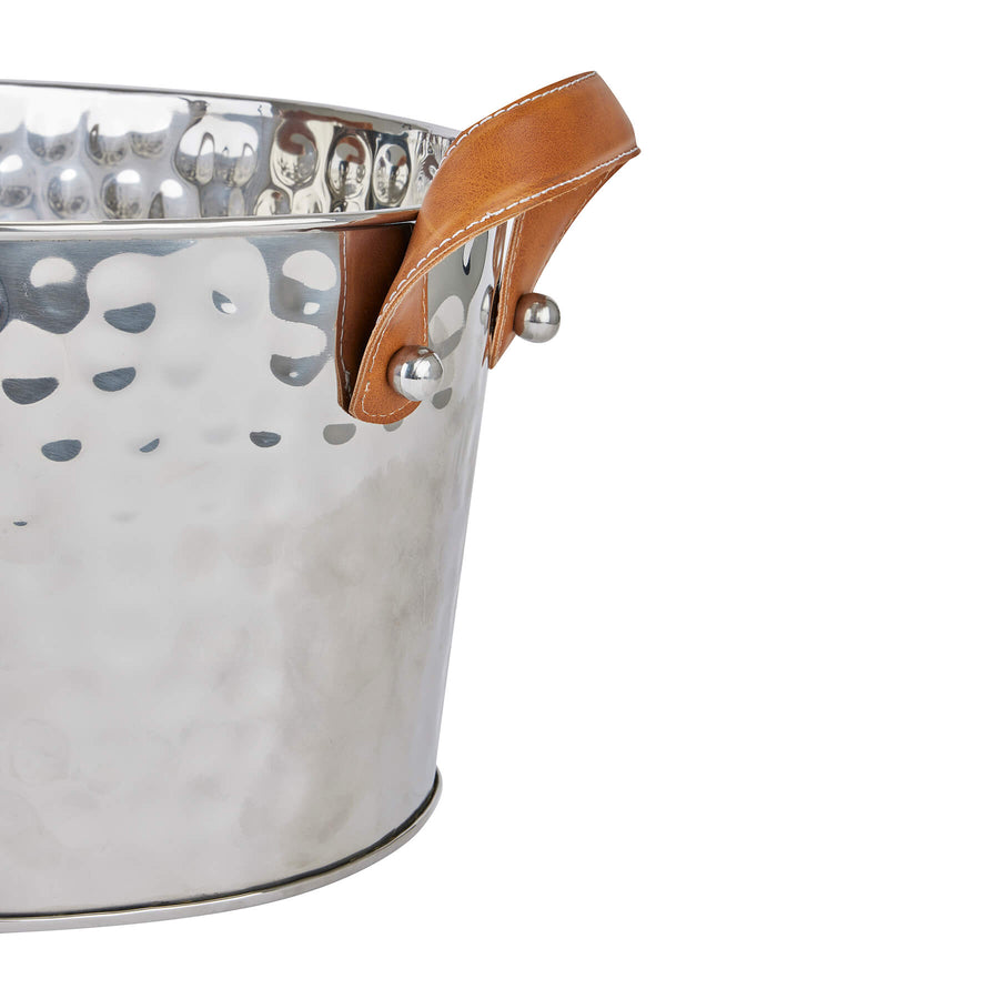 Silver champagne cooler with hand-hammered metal and leather handles, perfect for elegant entertaining by Sostter at brixbailey.com