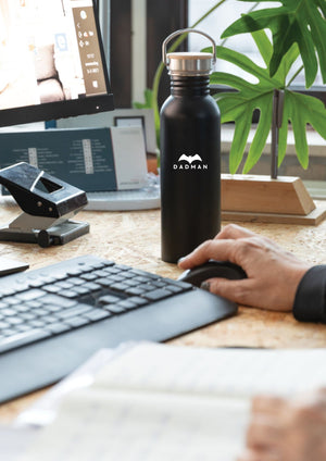 a soft-lit view of the dadman thermos with its warm bamboo lid and cozy handle
