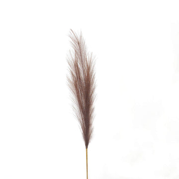 Lifelike taupe faux pampas grass plume, 85cm tall with feathery texture, perfect for boho or modern home decor by Sostter at brixbailey.com