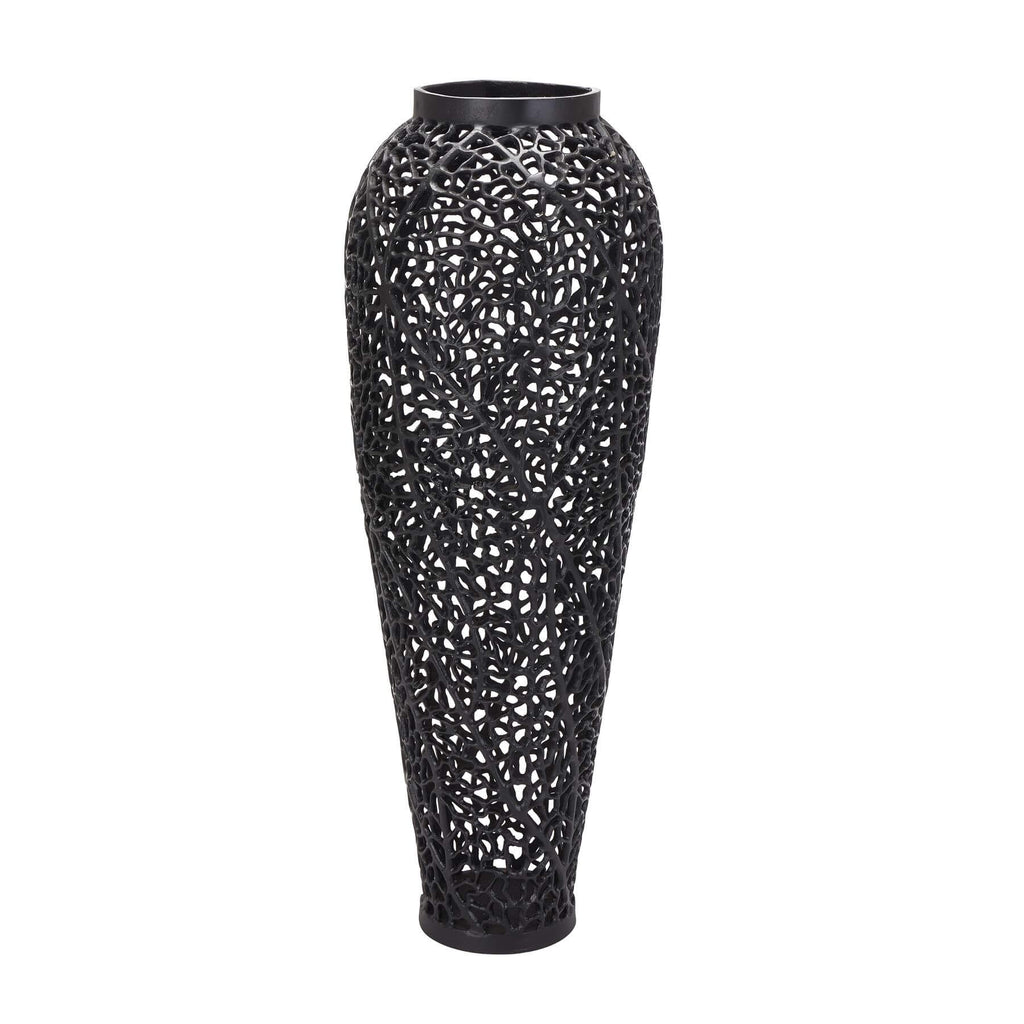 Matte black perforated steel vase with geometric cutouts, creating dynamic light patterns, 90cm tall, modern home decor by Sostter at brixbailey.com