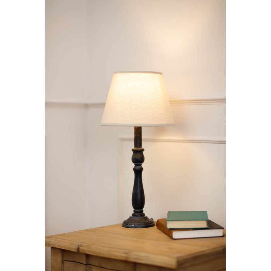 Ravenna Column Table Lamp with distressed black wood base and neutral linen shade for rustic-modern decor by Sostter at brixbailey.com
