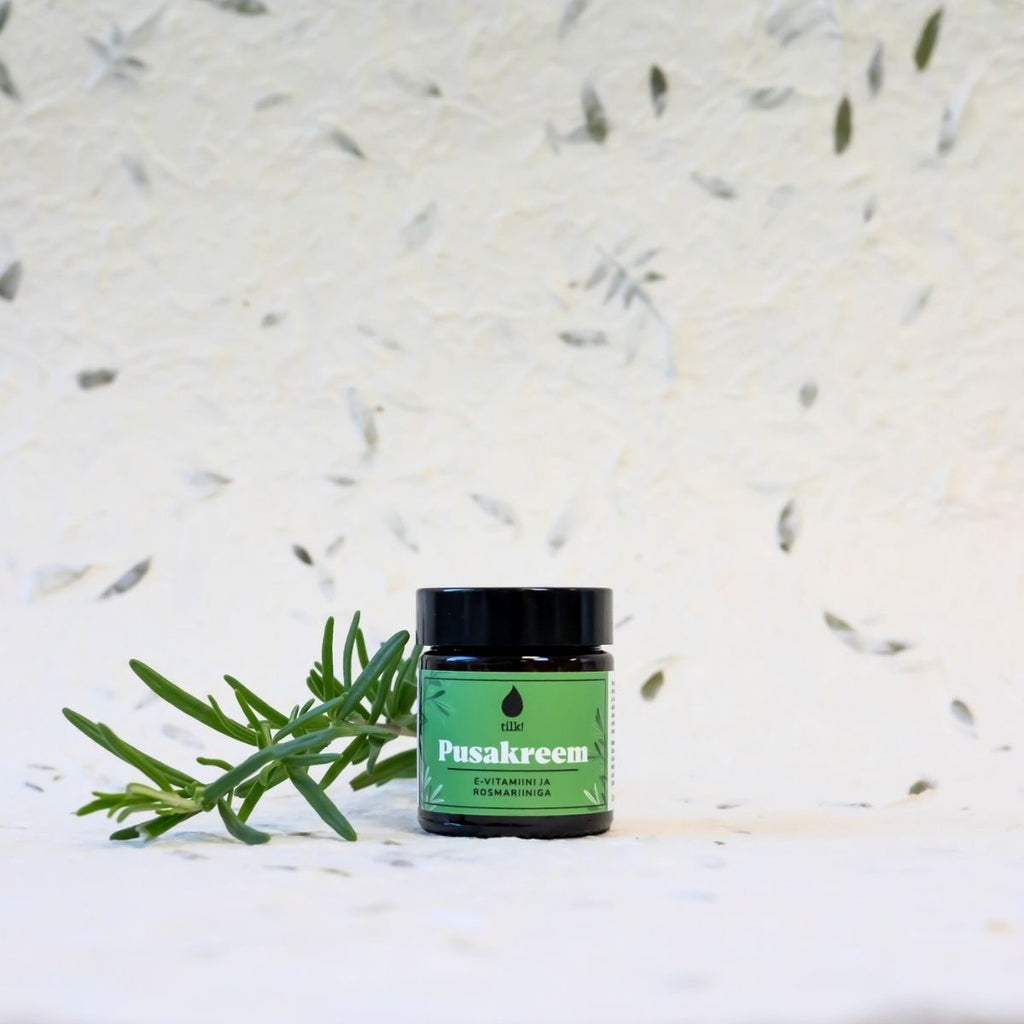 soft golden light on a 30ml bottle of rosemary-peppermint detangling cream, shea butter glistening on fingertips