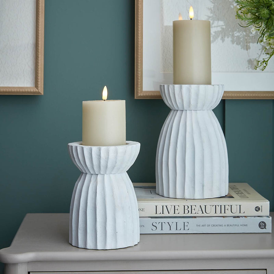 White carved glass hurricane lantern with intricate geometric patterns, warm atmospheric glow, traditional design. by Sostter at brixbailey.com