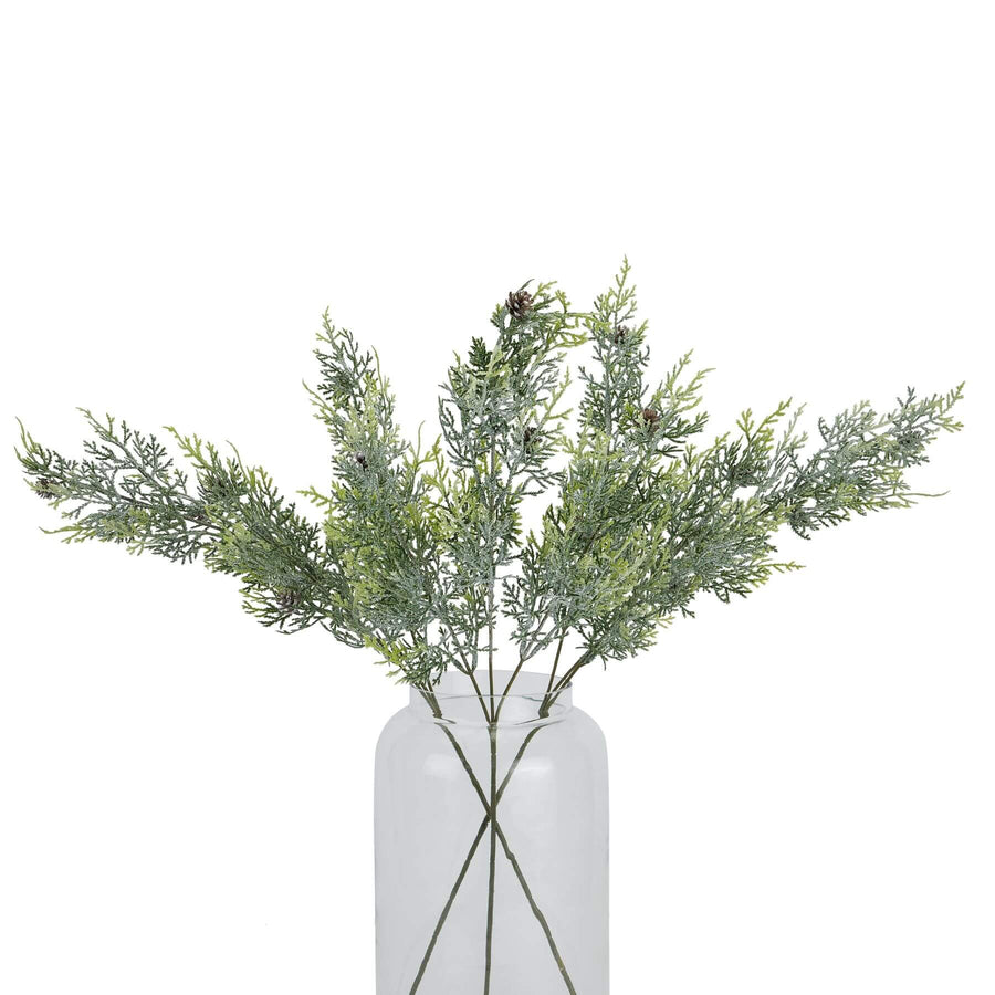 Lifelike frosted pine stem arrangement with crystalline-dusted needles and natural pinecones for winter decor by Sostter at brixbailey.com