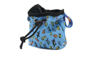 soft blue graffiti dog treat bag with a carabiner clip in a cozy home setting