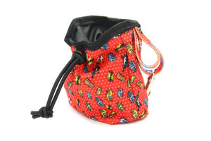 a soft-focused close-up of the red graffiti dog treat bag with its carabiner clip