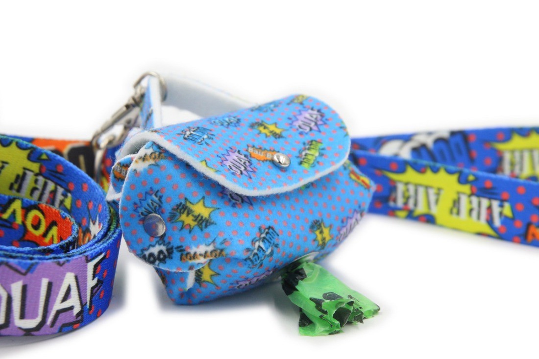 functional graffiti dog bag dispenser clipped to a leash in golden hour light