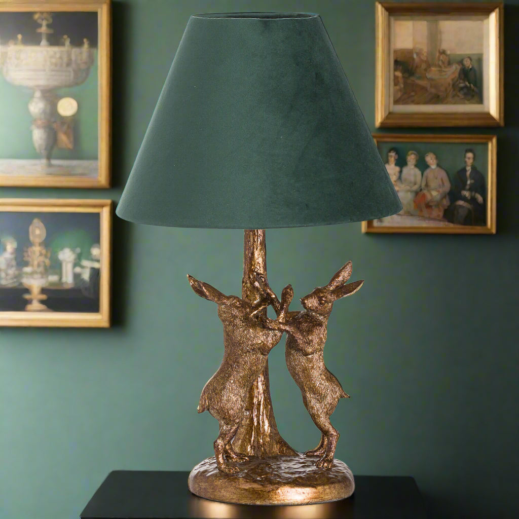 Antique gold marching hare lamp with green velvet shade, handcrafted resin sculpture, warm ambient lighting by Sostter at brixbailey.com