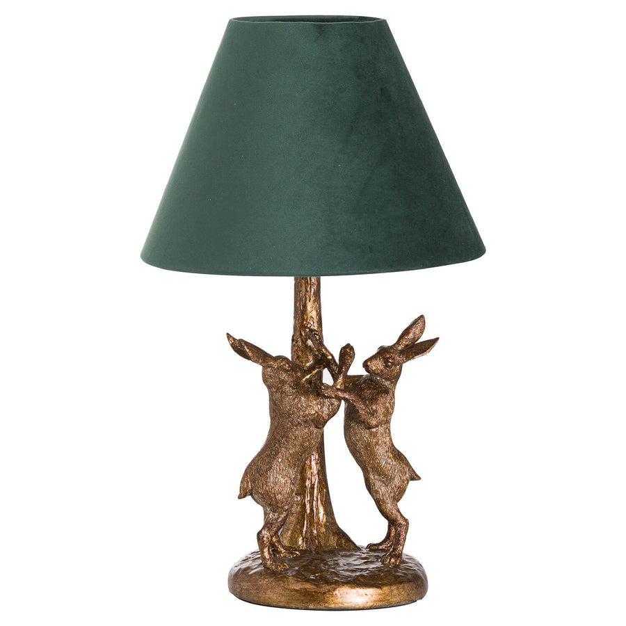 Antique gold marching hare lamp with green velvet shade, handcrafted resin sculpture, warm ambient lighting by Sostter at brixbailey.com