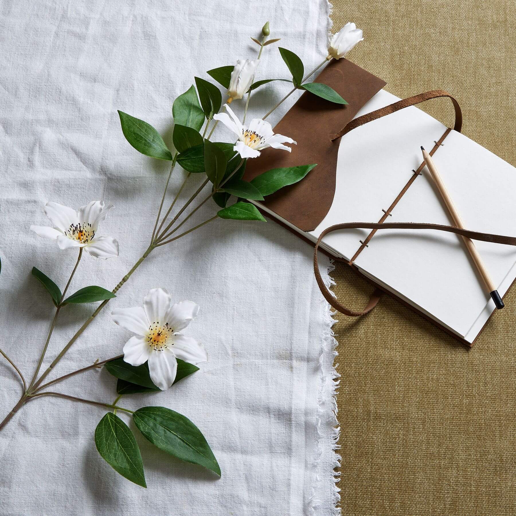 Lifelike white artificial clematis stems with green foliage, 30-inch hyper-realistic plastic flowers for home decor by Sostter at brixbailey.com