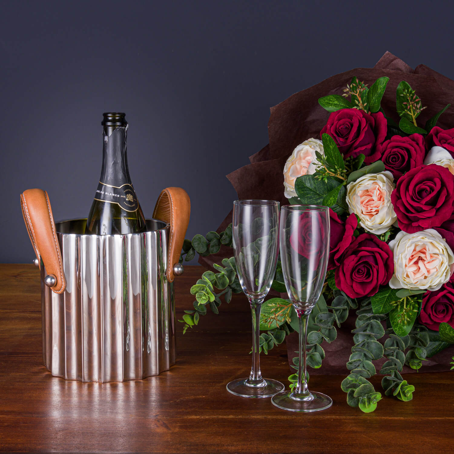 Silver fluted champagne cooler with leather handles, stainless steel, elegant ridges for light reflection, versatile centerpiece by Sostter at brixbailey.com