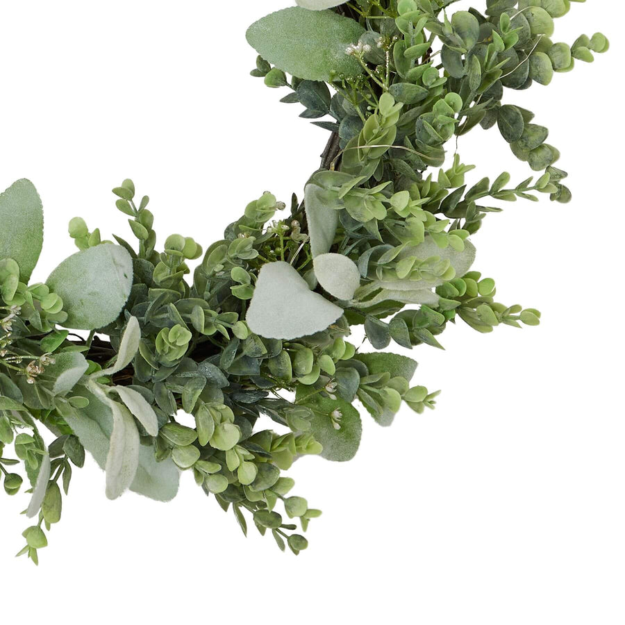 Handcrafted LED winter wreath with eucalyptus and lamb's ear foliage, glowing warm white lights on rustic green base by Sostter at brixbailey.com