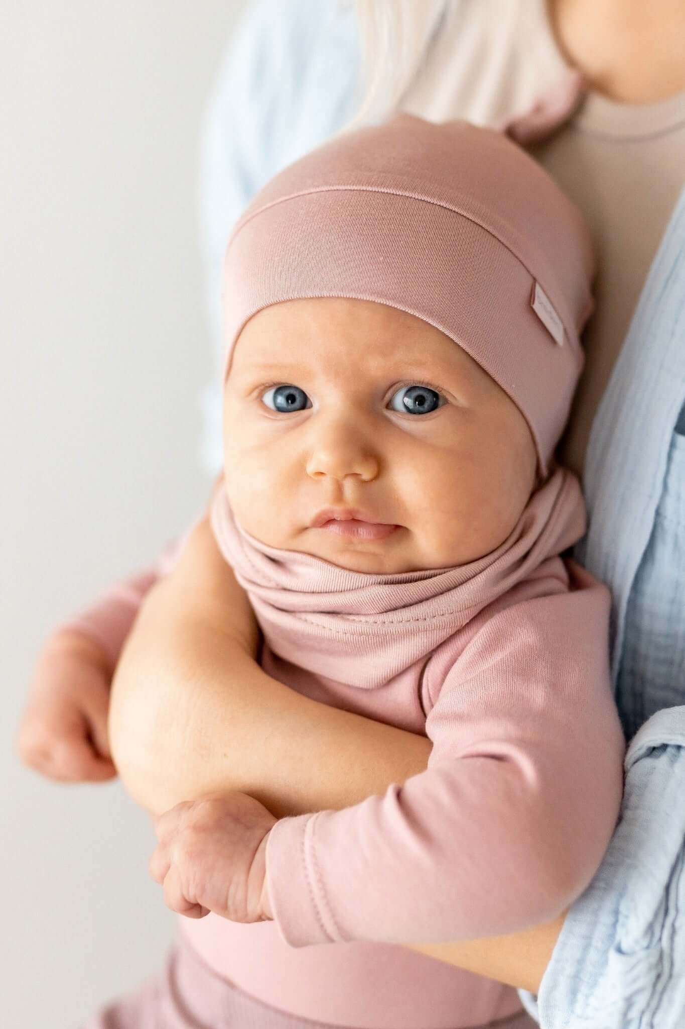 confident baby in a stylish bamboo sun hat with an adjustable knot, bold and protected