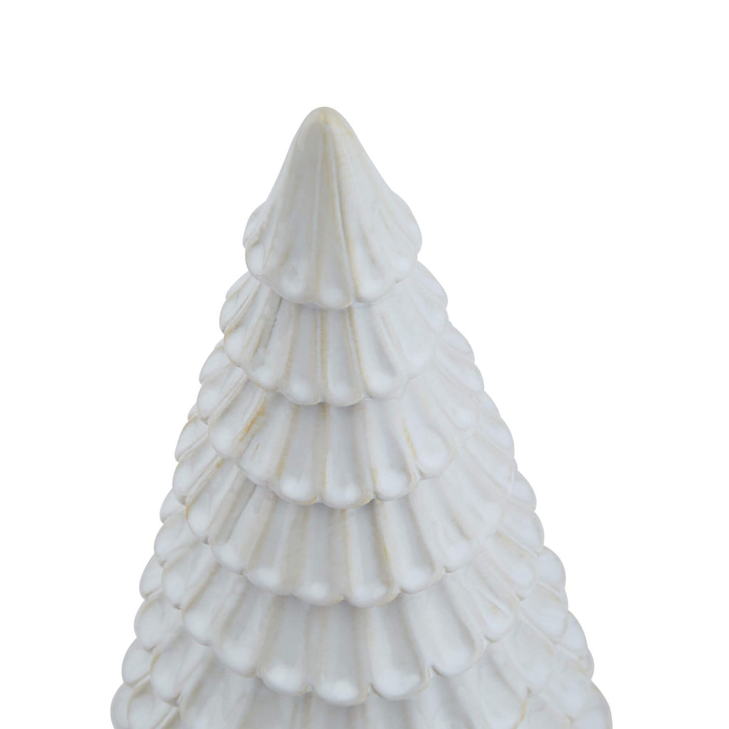 Handcrafted white ceramic fir tree sculpture with minimalist Nordic design, casting geometric shadows. by Sostter at brixbailey.com