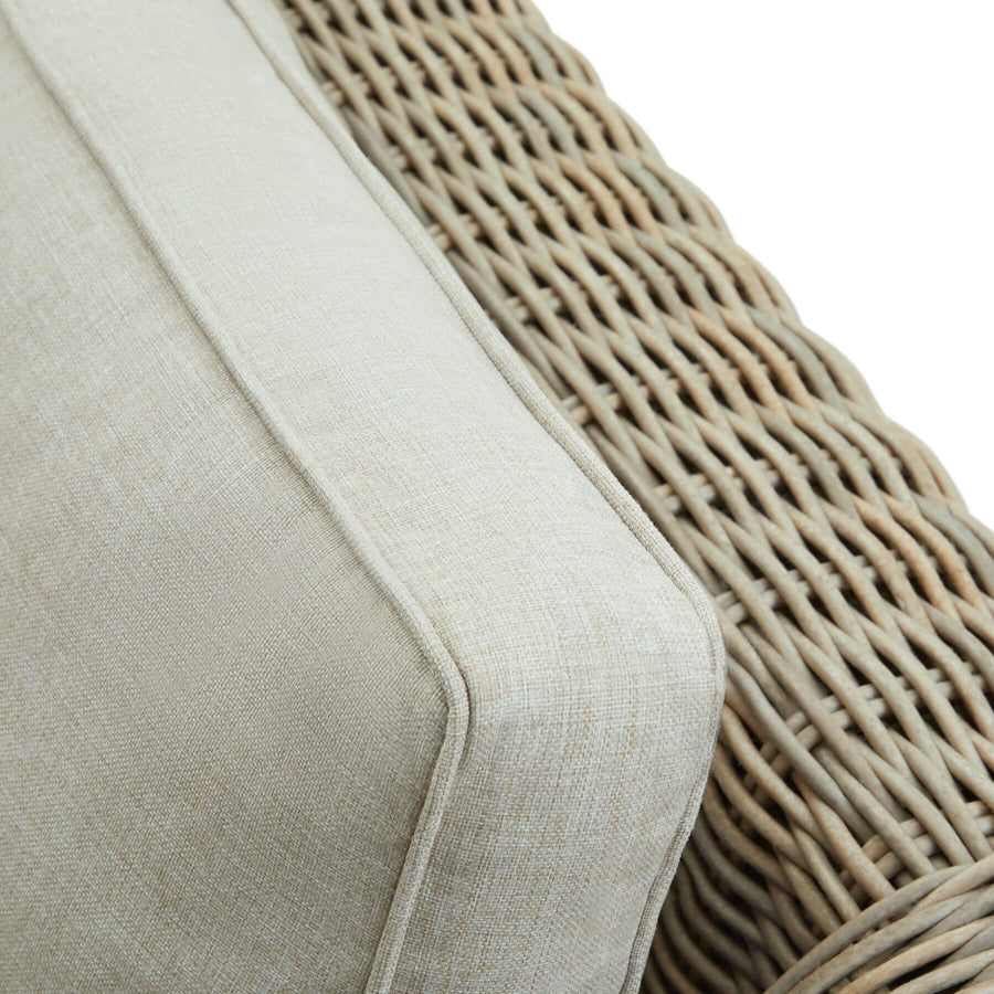 Handcrafted beige HDPE wicker sofa with acacia wood feet and UV-resistant cushions for outdoor patio luxury by Sostter at brixbailey.com