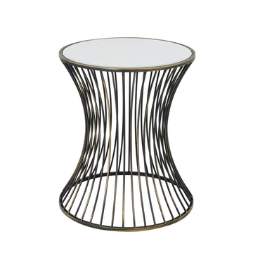 Handcrafted brass side table with black patina finish, concave silhouette, and mirrored glass surface for modern interiors. by Sostter at brixbailey.com