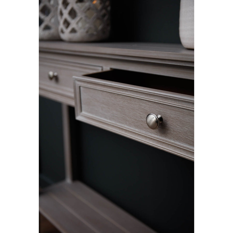 Distressed grey four-drawer console table with solid wood construction and transitional design for living rooms by Sostter at brixbailey.com