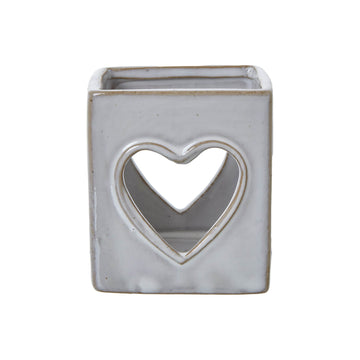 White ceramic tealight holder with heart cutout, Scandinavian minimalist design, projects romantic light patterns. by Hill Interiors at brixbailey.com