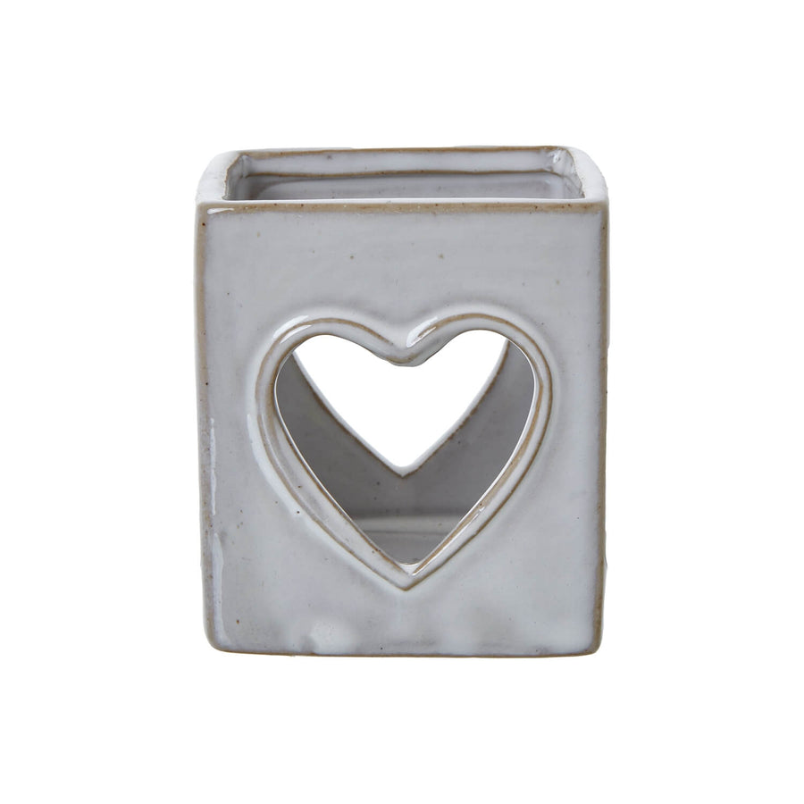 White ceramic tealight holder with heart cutout, Scandinavian minimalist design, projects romantic light patterns. by Hill Interiors at brixbailey.com