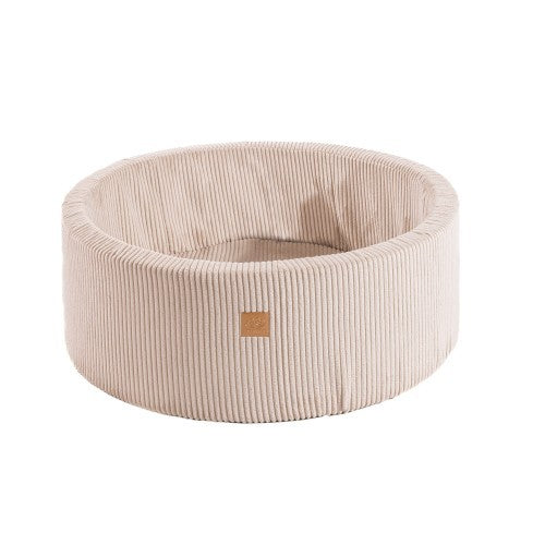 a bold, stylish ecru foam ball pit for kids, shown empty and ready for imaginative play