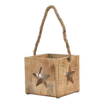 Handcrafted natural wooden star tealight holder with glass insert, casting warm glow and intricate shadow patterns. by Sostter at brixbailey.com